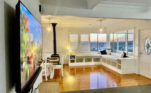 a living room with a couch and a table at 'Bellevue Manor' on Beauty Point in Wagga Wagga