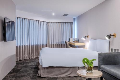 a hotel room with a bed and a couch at Retro Taichung in Taichung
