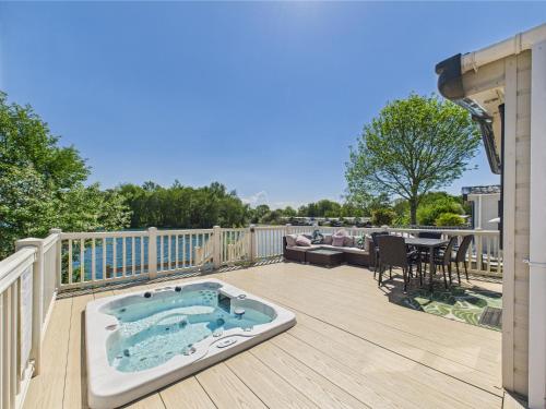 a hot tub on the deck of a house at Tattershall Lakes Mini Breaks - Fishing Lake Two in Lincoln
