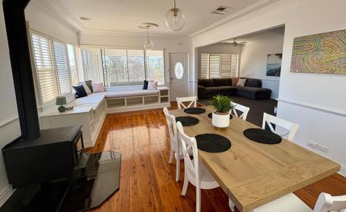 a living room with a table and a couch at 'Bellevue Manor' on Beauty Point in Wagga Wagga