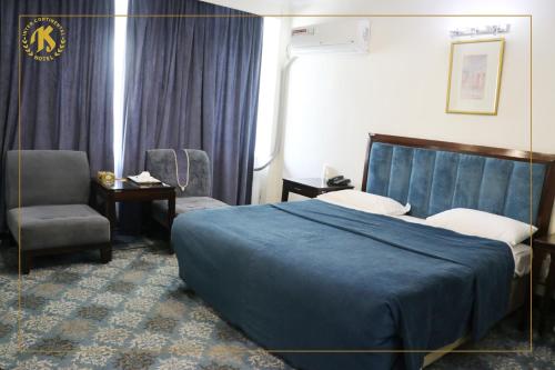 a hotel room with a bed and a chair at Hotel Intercontinental Kabul in Kabul
