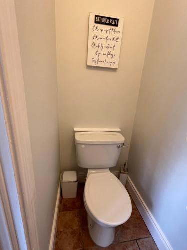 a bathroom with a toilet and a sign on the wall at Stone House , Boyne Valley Views in Donore