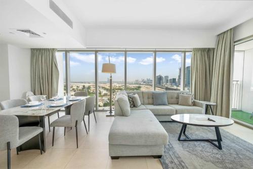 a living room with a couch and a table at New Stunning 4 BR Burj Khalifa View in Dubai