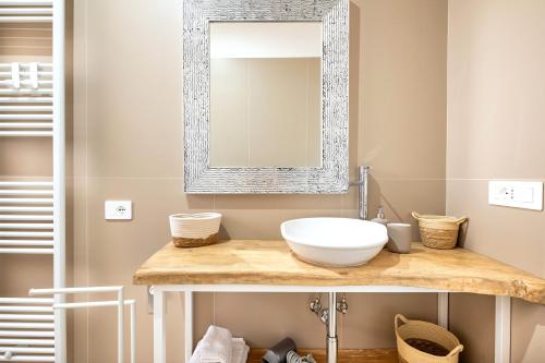 a bathroom with a sink and a mirror at Helianthus in Cisternino