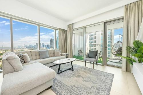 a living room with a couch and large windows at New Stunning 4 BR Burj Khalifa View in Dubai