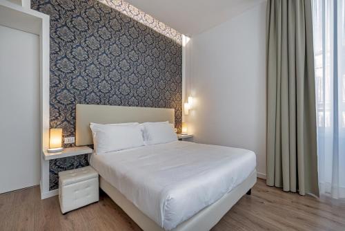 Postel nebo postele na pokoji v ubytování Sanremo Luxury Suites