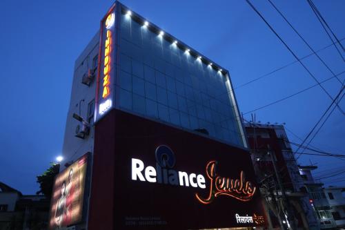 a building with a neon sign on the side of it at Innduza Inn in Begusarai