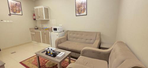 a living room with a couch and a table at افاق سويت للشقق المخدومة السلي in Riyadh