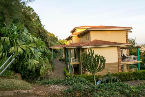 a house on the side of a hill at Enkombe Place in Kampala