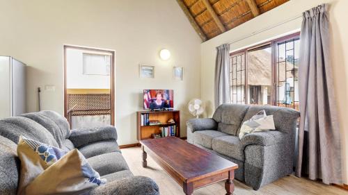 a living room with two chairs and a coffee table at Emerald Cove in Shelly Beach