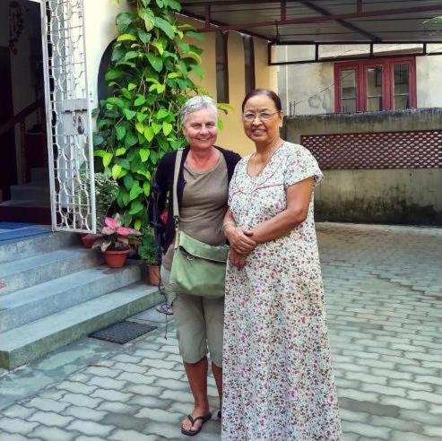 two older women standing in front of a building at Bhaskar Homestay - The Bungalow in Dibrugarh