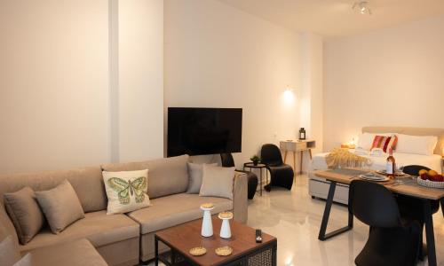 a living room with a couch and a table at Seaside Breeze Studio in Agios Nikolaos