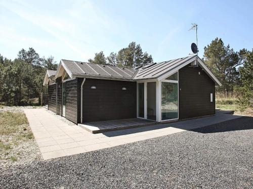 a small house with a roof on a gravel driveway at Tranquil Retreat in Nature - By Traum Ferienwohnungen in Ålbæk