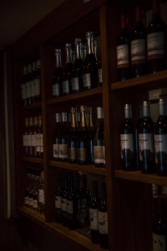 a shelf filled with lots of bottles of wine at Allerdale Court Hotel in Cockermouth