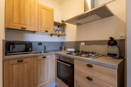 a kitchen with a sink and a stove top oven at CS Holiday in Castelnuovo Berardenga