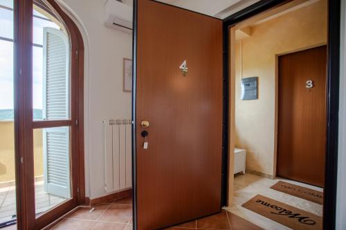 a wooden door in a room with a window at CS Holiday in Castelnuovo Berardenga