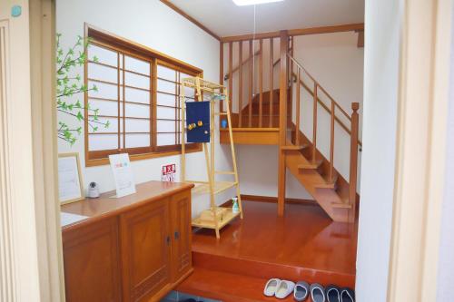 a room with a staircase and a wooden floor at 立花荘 in Matsuyama