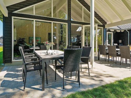 a dining table and chairs on a patio at 5 star holiday home in Kappeln in Kappeln