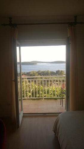 a bedroom with a door open to a balcony at J&B Holiday House Hvar in Hvar