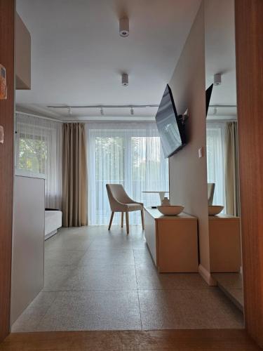 a living room with a desk and a tv in a room at Sileo Apart No.85 in Ustka