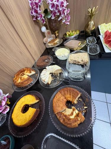 a table with pies and other desserts on it at Hotel Ferrari in Rio do Sul