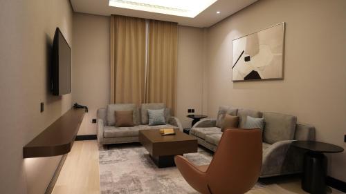a living room with a couch and a table at Snood Al Narjis Hotel in Riyadh