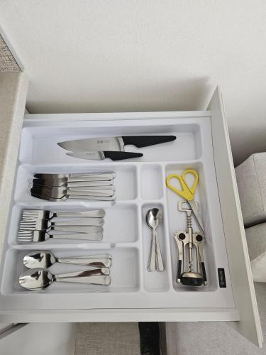 a white drawer filled with lots of kitchen utensils at Sileo Apart No.85 in Ustka