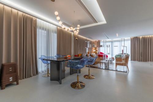 a living room with blue chairs and a table at TML urban 4 bedroom 6 bathroom villa private KTV room and swimming pool in Pattaya South