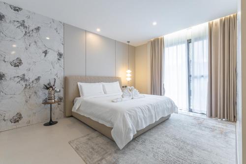 a bedroom with a bed and a large window at TML urban 4 bedroom 6 bathroom villa private KTV room and swimming pool in Pattaya South