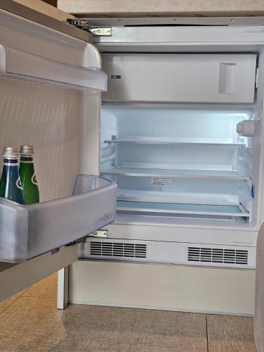 an open refrigerator with two bottles of beer in it at Sileo Apart No.85 in Ustka