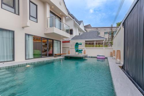 a swimming pool in the backyard of a house at TML urban 4 bedroom 6 bathroom villa private KTV room and swimming pool in Pattaya South