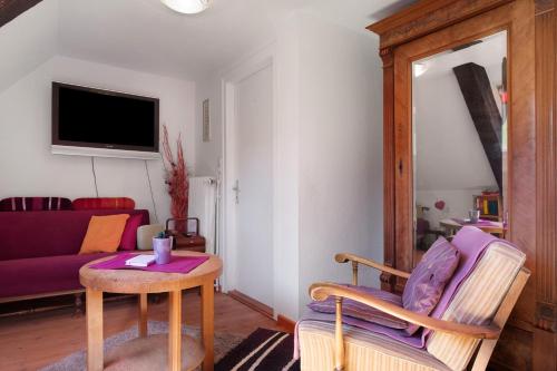 a living room with a table and a couch at Grundhäusle Gütenbach in Gütenbach