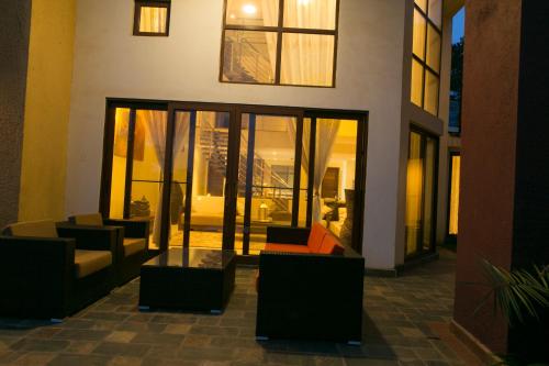 a lobby with couches and windows in a building at Enkombe Place in Kampala