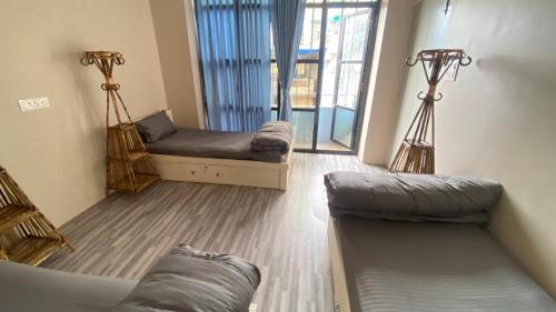 a living room with a couch and a window at Verve Nepal's Hostel in Kathmandu