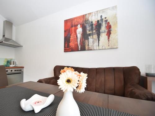 a vase with a flower on a table in a kitchen at Wohnung in Willingen nahe Ettelsberg-Bahn in Willingen