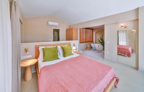 a bedroom with a large bed with green pillows at Terranova Villas in Cukurbag