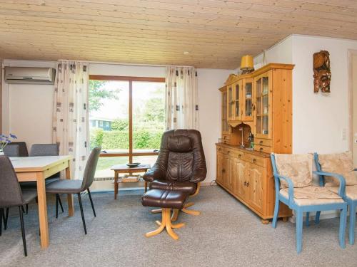 a living room with a chair and a table at 4 person holiday home in Juelsminde-By Traum in Snaptun
