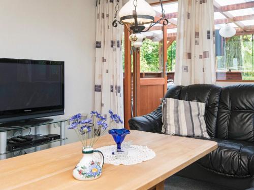 a living room with a couch and a coffee table at 4 person holiday home in Juelsminde-By Traum in Snaptun