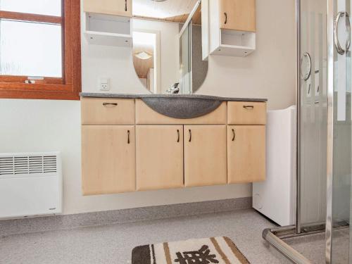 a bathroom with a sink and a mirror at 4 person holiday home in Juelsminde-By Traum in Snaptun