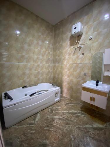 a bathroom with a tub and a sink at Kstephen Apartment in Lekki