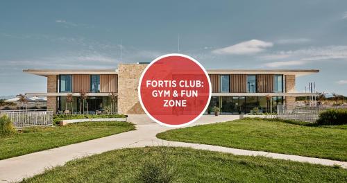 a red sign in front of a building at Falkensteiner Residences Senia in Petrcane