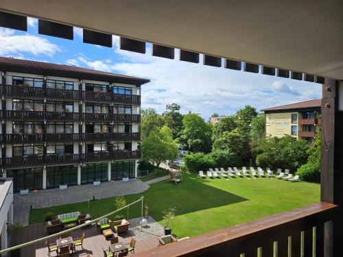 a view from a balcony of a building with a yard at Johannesbad Hotel Königshof in Bad Füssing