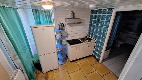 a small kitchen with a sink and a refrigerator at Jūrmala beach in Jūrmala
