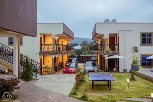 a view of a courtyard of a house with a table at AIDEN HOMES AND APARTMENTS HOTEl in Koforidua