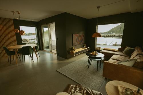 a living room with a couch and a table at #Lofoten Leilighet ved sjøen in Ballstad