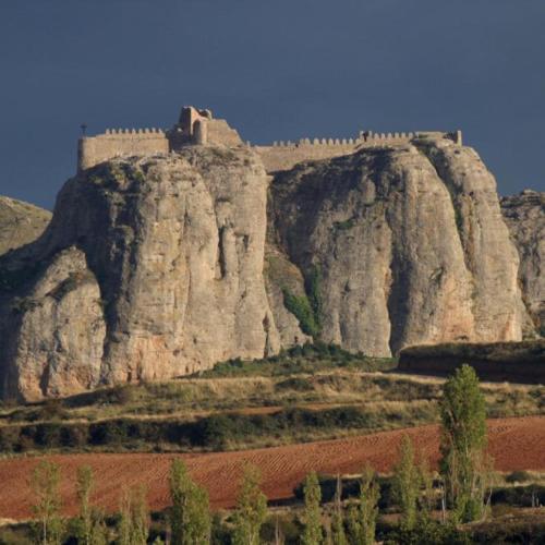 a castle on the side of a rocky mountain at La Casa Verde in Islallana