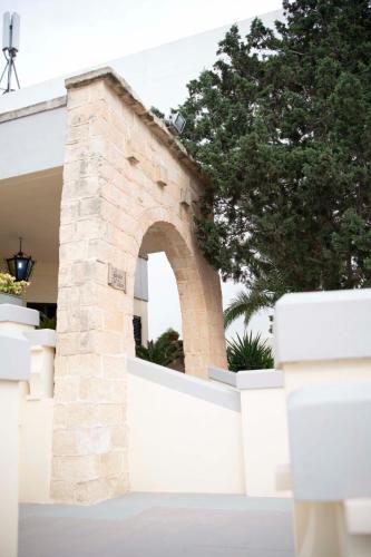 a brick archway in a white fence in front of a house at Fun for all the family! in Żebbieħ