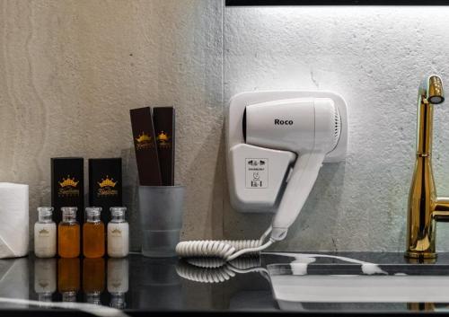 a hair dryer on a counter next to a wall at Kazakhstan Hotel in Almaty