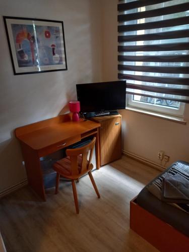 a desk with a computer and a chair in a room at Hotel Restaurant zur Gondel in Bitterfeld
