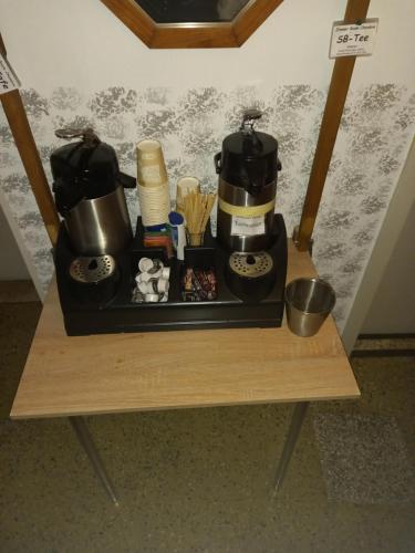 a tray with a coffee maker on a table at Hotel Restaurant zur Gondel in Bitterfeld